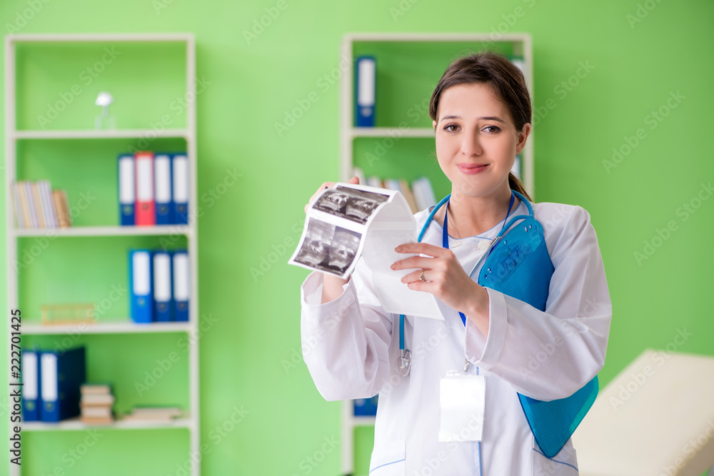 Female doctor gynecologyst writing medical record in the clinic Female doctor gynecologyst writing medical record in the clinic