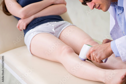 Young woman visiting doctor dermatologist 