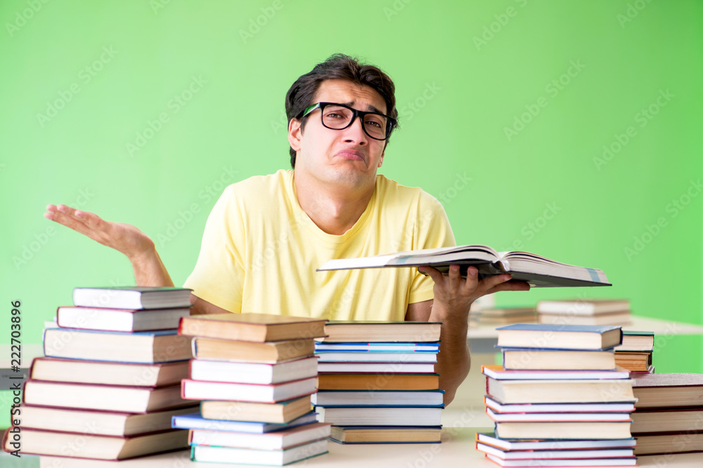 Student with too many books to read before exam Student with too many books to read before exam