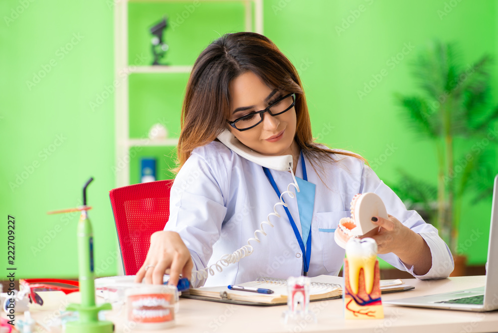 Woman dentist working on teeth implant Woman dentist working on teeth implant