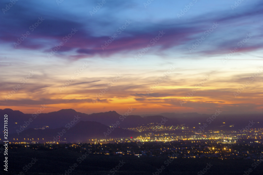 Open sky at sunset with colorful pattern and silhouette of mountains in the background Open sky at sunset with colorful pattern and silhouette of mountains in the background