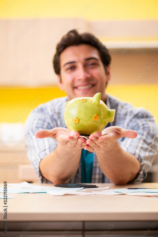 Fototapeta premium Young man husband in budget planning concept