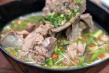 Hot and spicy pork spare rib soup with tamarind and Thai herbs in bowl, Tom yum, Hot and sour soup.