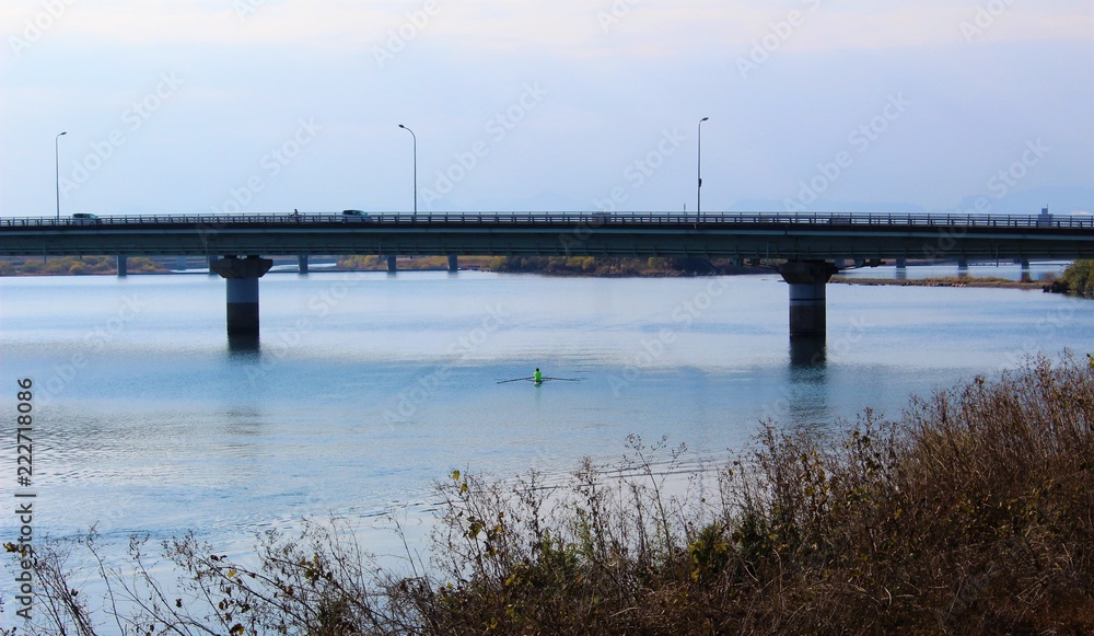 A bridge over calm Kuma River in winter scenery
