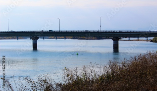 A bridge over calm Kuma River in winter scenery © octobersun
