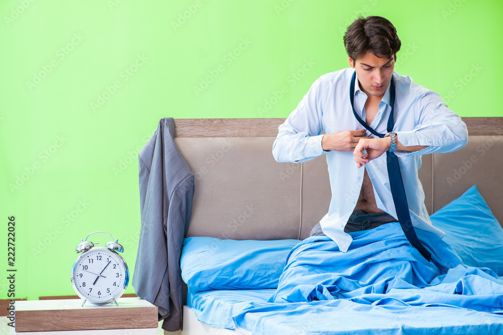 Fototapeta premium Employee in the bedroom being late for his job in time managemen