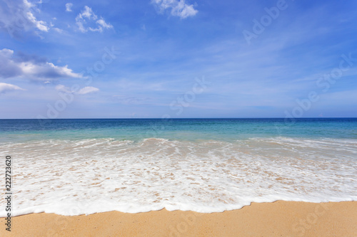 Beautiful tropical beach in summer season with wave crashing on sandy shore at phuket thailand image for nature background and summer design background.