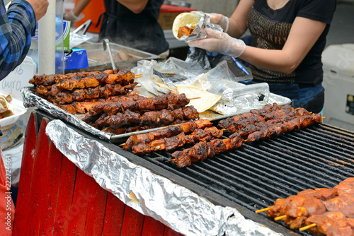 Canvas Print BBQ meat on grill from street vendor in the city