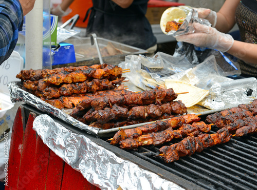 Photography BBQ meat on grill from street vendor in the city