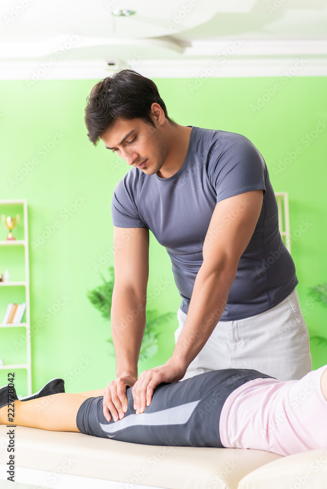 Young doctor chiropractor massaging patient 