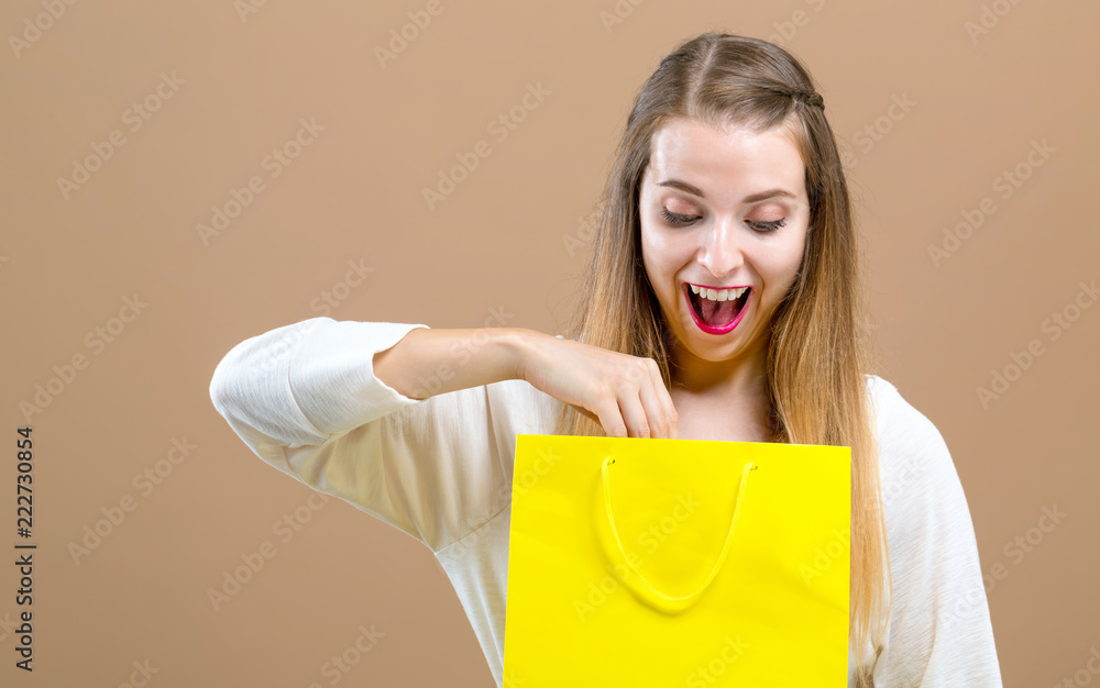 Woman with a shopping bags on a brown background Woman with a shopping bags on a brown background