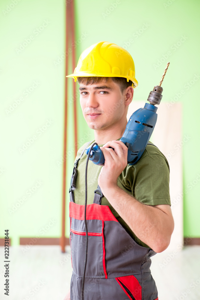 Young man carpenter working in workshop Young man carpenter working in workshop