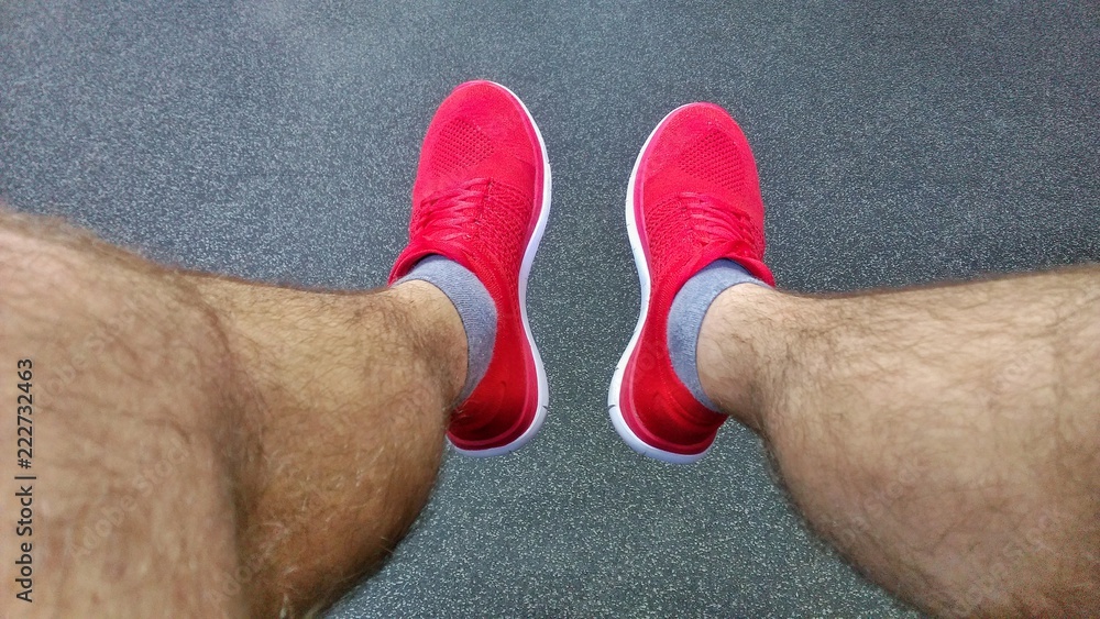 sneakers red on male hairy legs Stock Photo | Adobe Stock