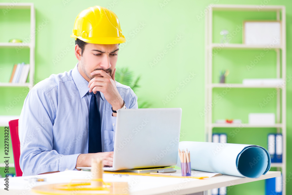 Young male architect working at the project Young male architect working at the project