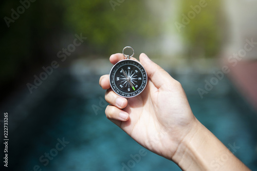 Hand holding compass