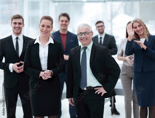 serious businessman and business woman on the background of the office staff. © ASDF