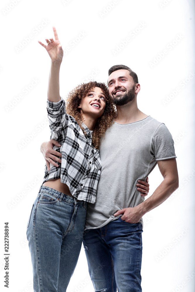 oung couple looking up and pointing upwards