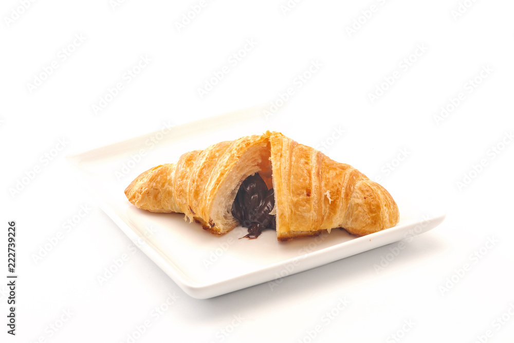 French croissants on wicker basket, bakery background