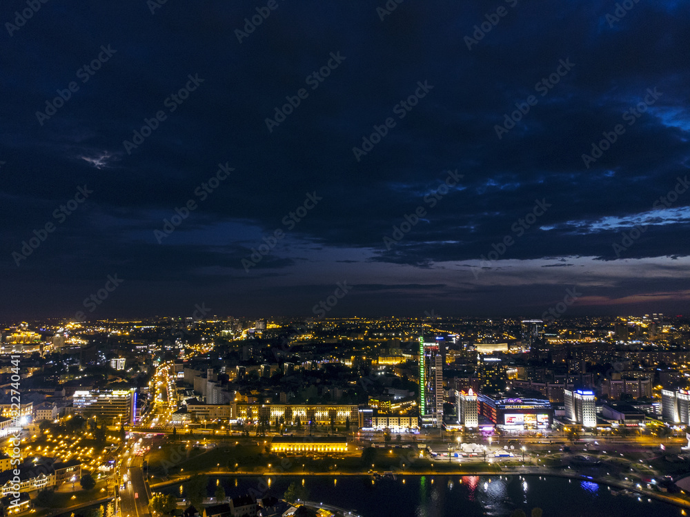 Aerial panoramic view of city center with modern buildings at midnight