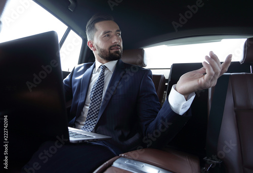 Confident businessman talking in car © ASDF