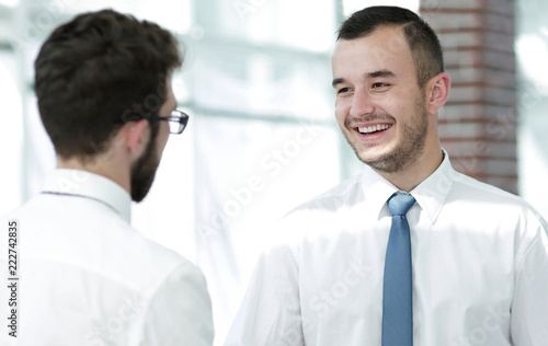 employees greet each other by shaking hands