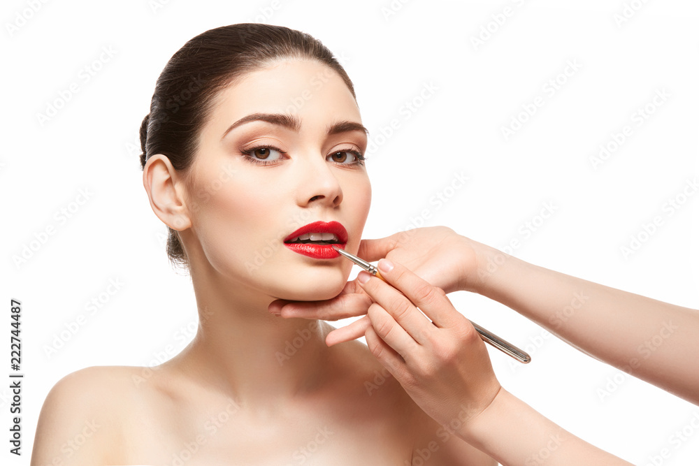girl applying red lipstick isolated on white girl applying red lipstick isolated on white