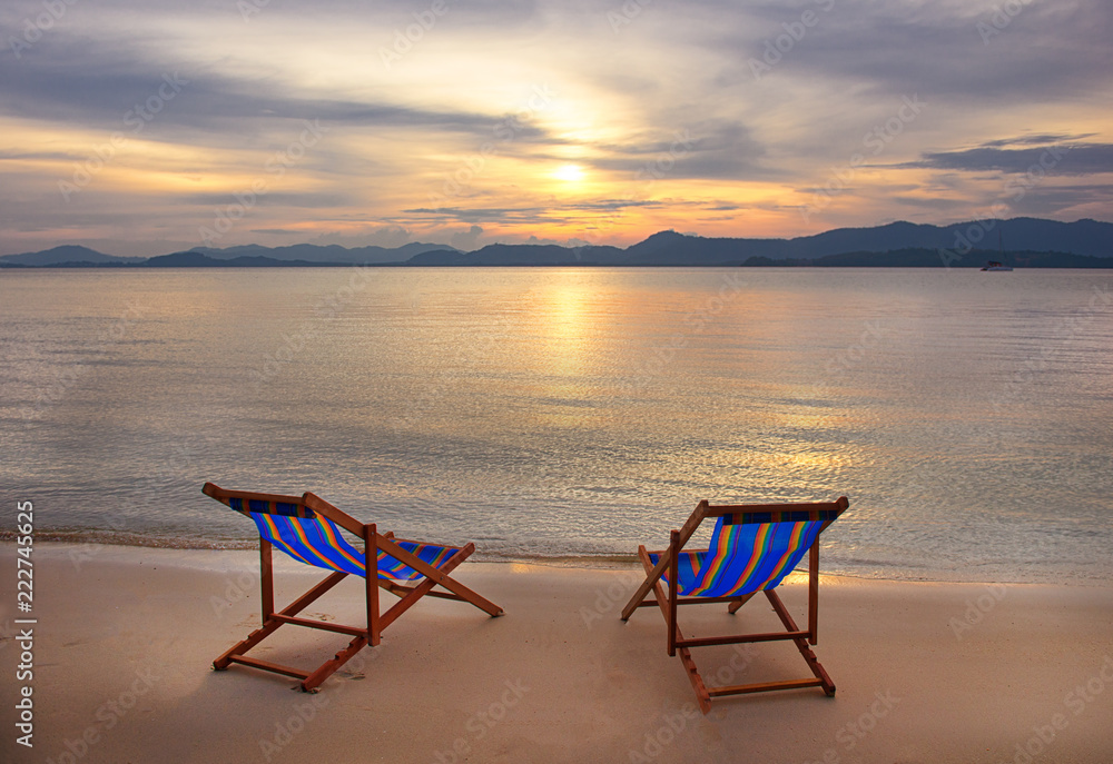 Two sunbed on topical beach ,Beach chairs on sand ,view sunset