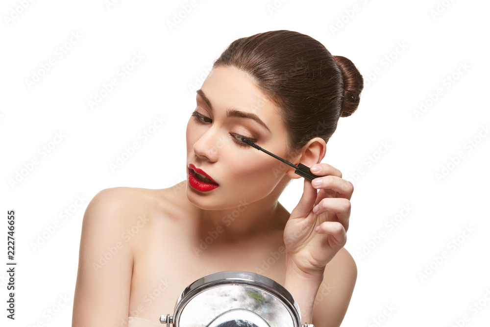girl applying eyelash mascara isolated on white girl applying eyelash mascara isolated on white