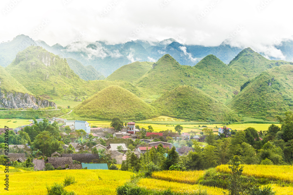 View of small village Fairy bosom in Tam Son town, Quan Ba District, Ha Giang Province, Vietnam.  colorful mixture of paddy fields and house roofs.Twin mountain,double mountain