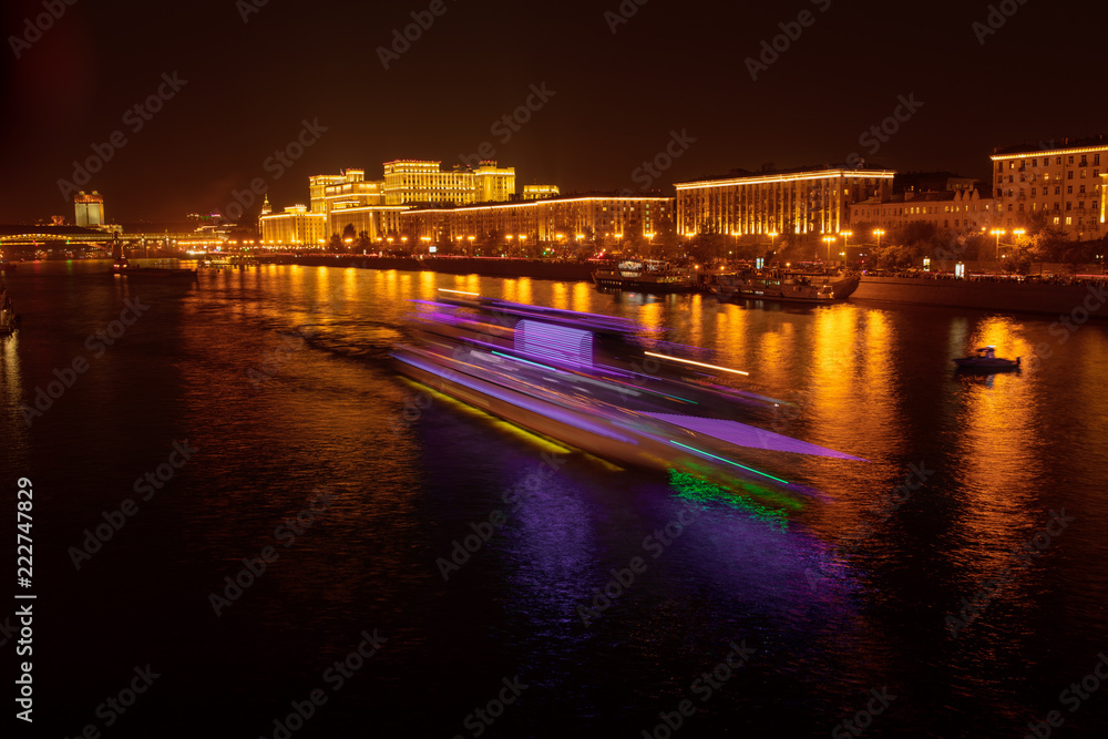 Moscow river with ships at night as background
