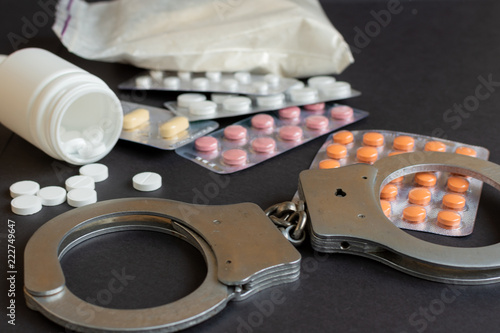Fotografie Drugs and handcuffs composition