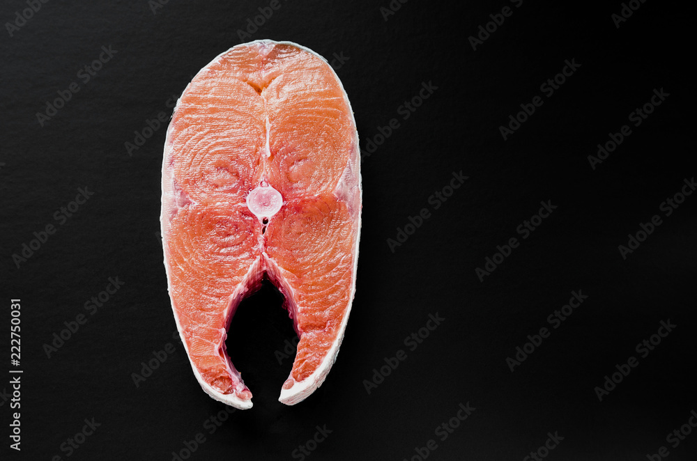Slice of Raw Pink Salmon Steak on Black Background Top View. Thick Piece of  Fresh Red Fish, Chum or Trout Stock Photo
