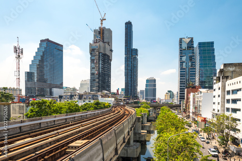 Skytrain and skyscraper in the central business district of the metropolis Bangkok photo