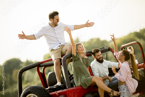 Happy friends having fun in convertible car at vacation © BGStock72