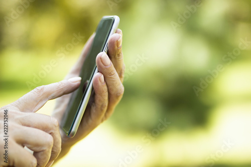Woman using smart phone wit...