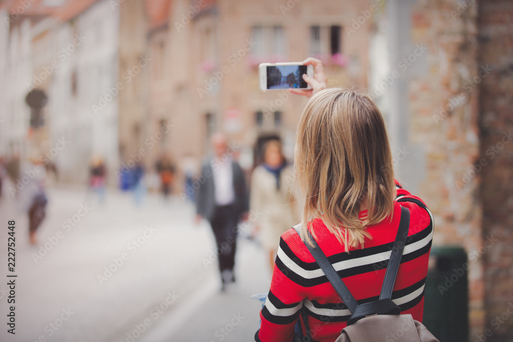 young girl in red sweater at streets of Bruges. Belgium, Atumn season young girl in red sweater at streets of Bruges. Belgium, Atumn season