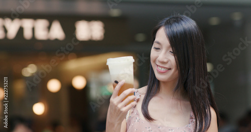 Woman drinking of cheese green tea at Heytea store in the city