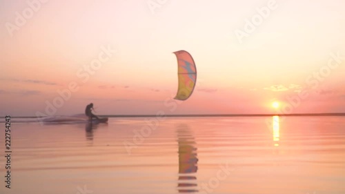 Reflection on the lake during sunset, the man controls the training kite photo