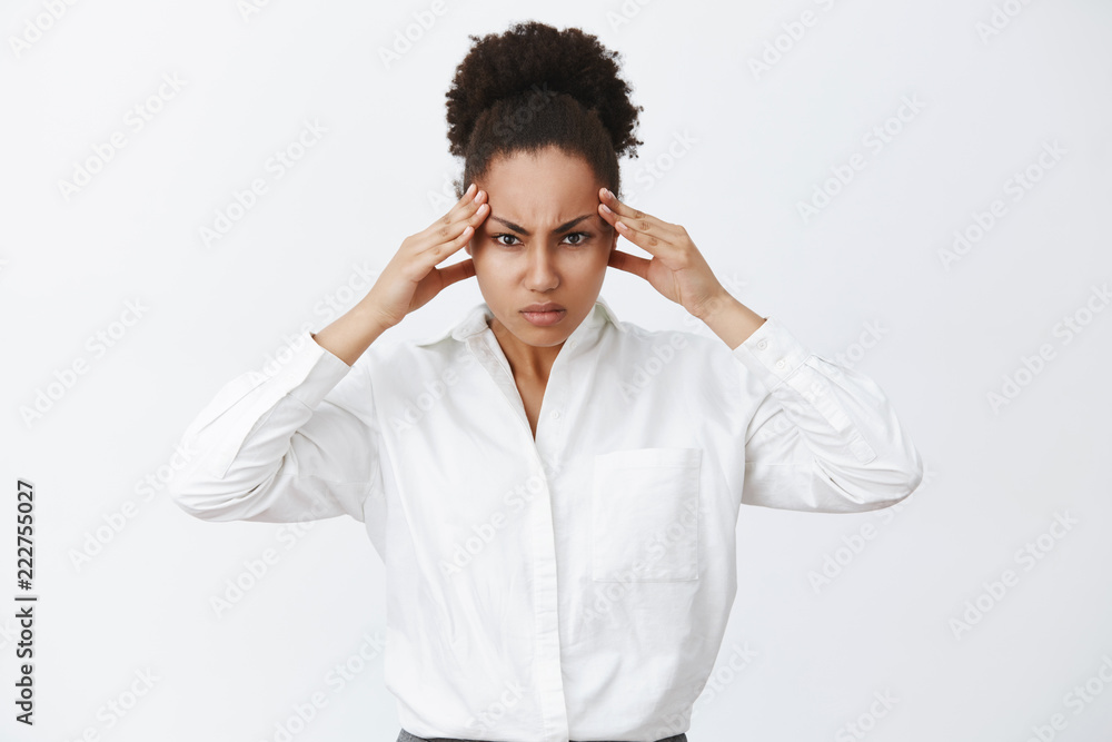 Woman trying focus, searching solutions in brain, being great strategist. Portrait of intense businesswoman trying concentrate, frowning, holding hands on temples, thinking hard to find solution Woman trying focus, searching solutions in brain, being great strategist. Portrait of intense businesswoman trying concentrate, frowning, holding hands on temples, thinking hard to find solution