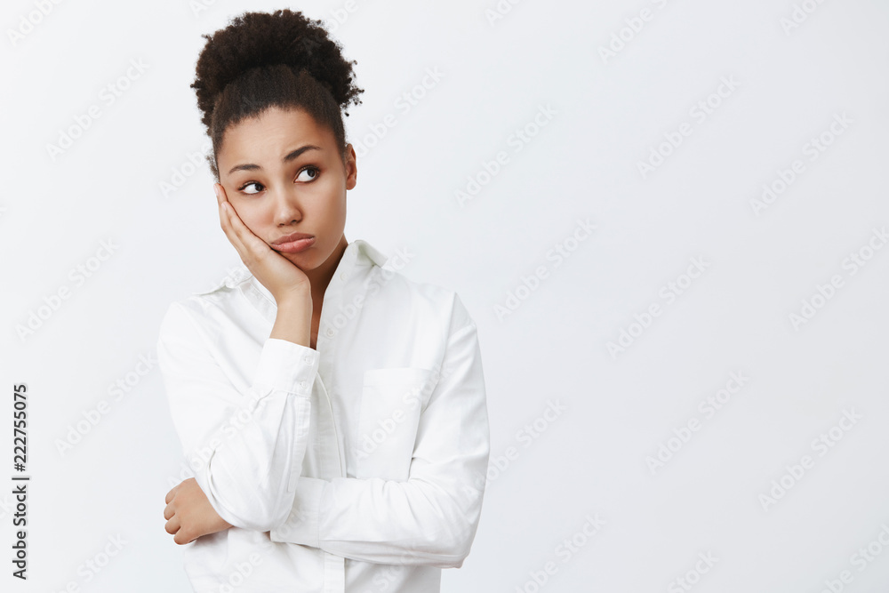 Woman wants go home, waiting clock ring to leave office. Portrait of dreamy tired and bored cute african-american female office worker, leaning on palm and gazing right, feeling boredom Woman wants go home, waiting clock ring to leave office. Portrait of dreamy tired and bored cute african-american female office worker, leaning on palm and gazing right, feeling boredom