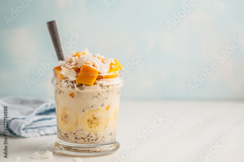 Overnight oatmeal with mango, coconut, banana and chia seeds.