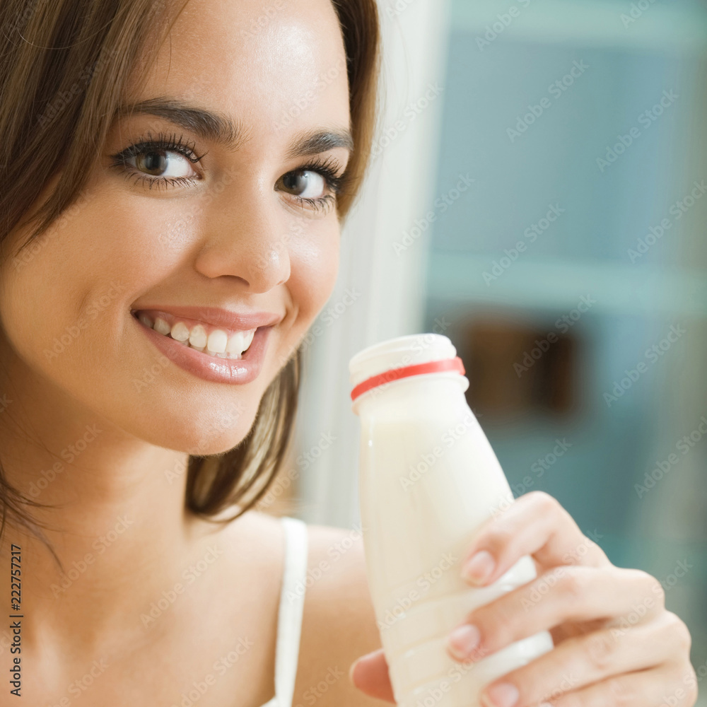 Portrait of young happy woman drinking milk at home Portrait of young happy woman drinking milk at home