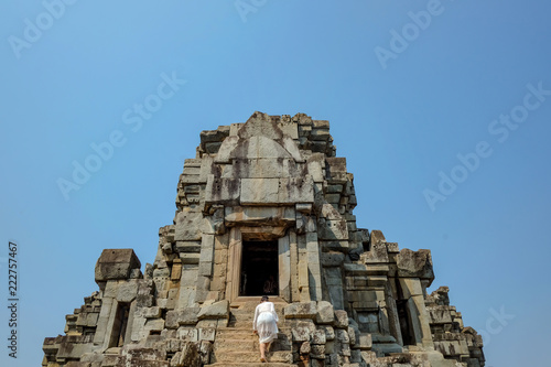 Asian women climb up to Ancient stone castle in Angkor wat Angkor Thom,wonder of the world.