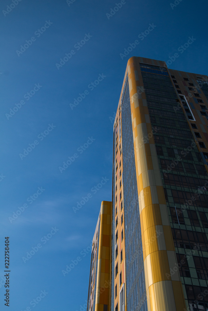 Fototapeta premium yellow and blue skyscrapper facade background