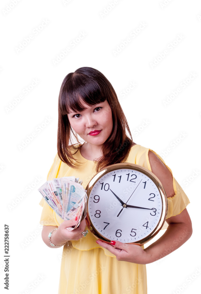 Brunette girl in yellow dress holding in his hand a large round clock and money Brunette girl in yellow dress holding in his hand a large round clock and money