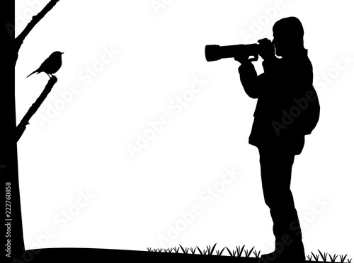 Birdwatcher photographs a bird silhouette