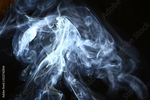 wonderful swirl glowing blue smoke on black background.
