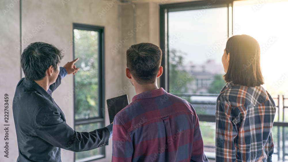 Real estate agent present a construction job building to customer home buyer Real estate agent present a construction job building to customer home buyer