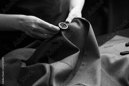 Sewing the buttons to the jacket photo