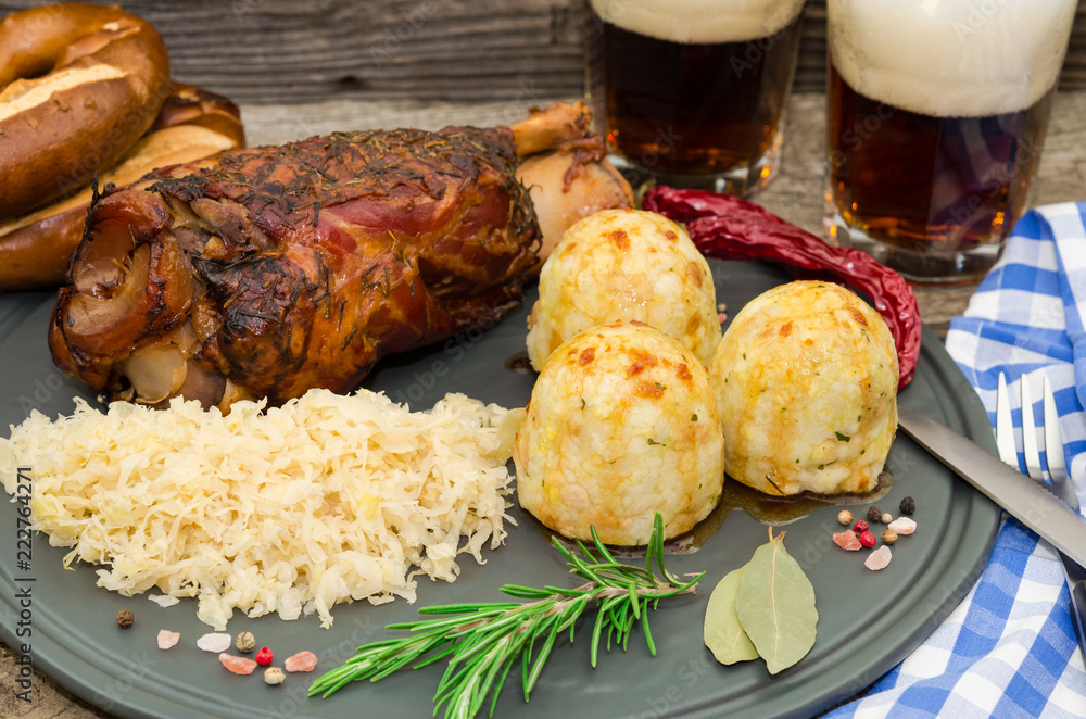 Grilled pork knuckle. Pork knuckle with beer, dumpling and sauerkraut